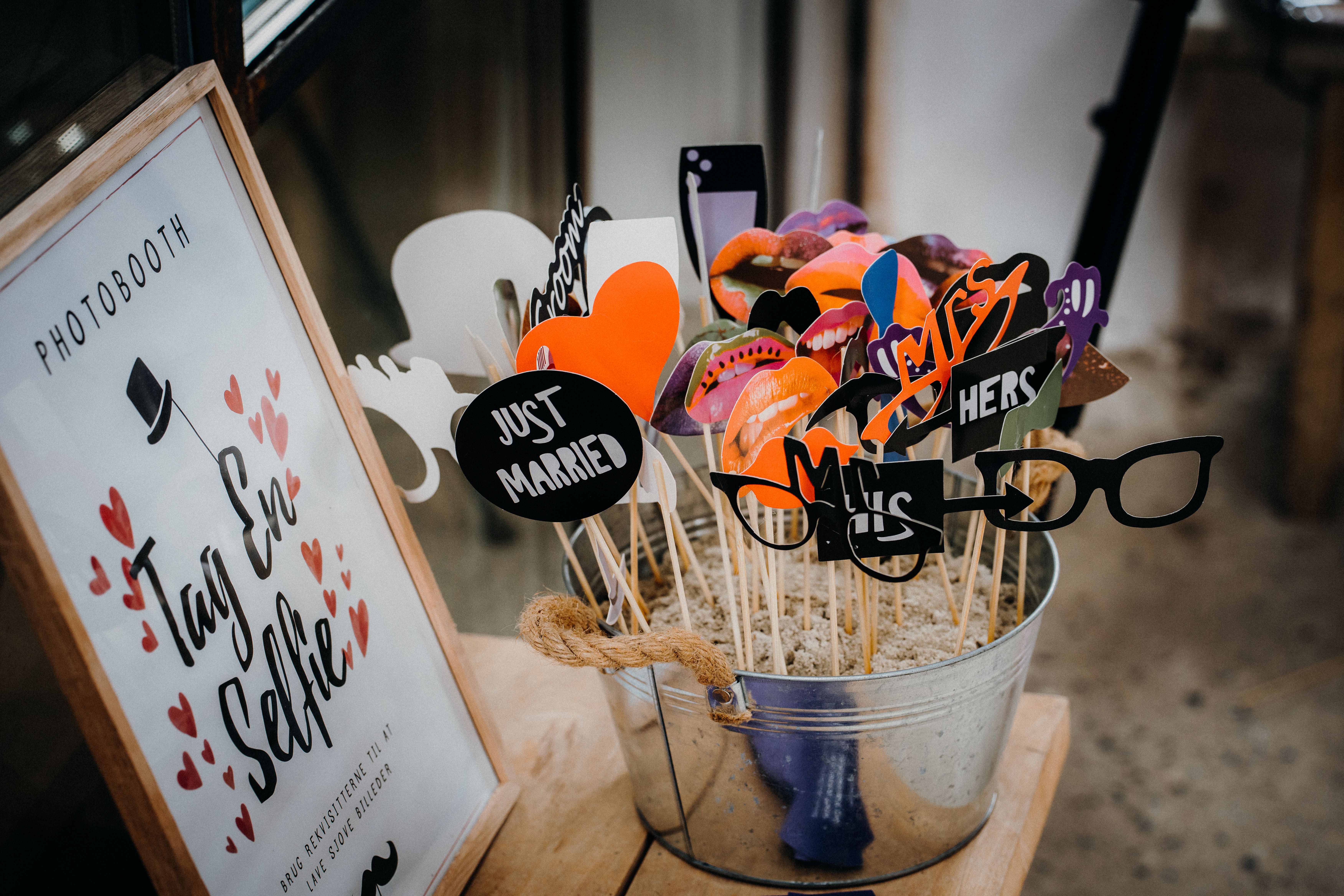 Guests having fun at a luxury open-air DSLR LA wedding photo booth with custom backdrop and props, celebrating an unforgettable LA wedding